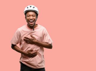 Poster - Black man wearing bike helmet confident and happy with a big natural smile laughing