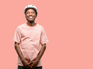 Poster - Black man wearing bike helmet thinking and looking up expressing doubt and wonder