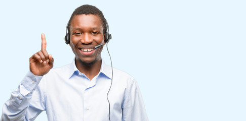 Poster - Black man consultant of call center happy and surprised cheering expressing wow gesture pointing up