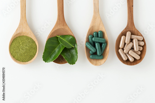 Fotografie, Obraz Herbal medicine in spoon on white background