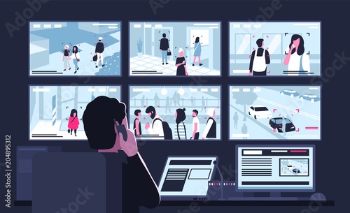 Security Service Worker Sitting In Dark Control Room In
