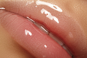 moisturizing lip balm, lipstick. close-up of a beautiful sexy wet lips. full lips with gloss makeup.