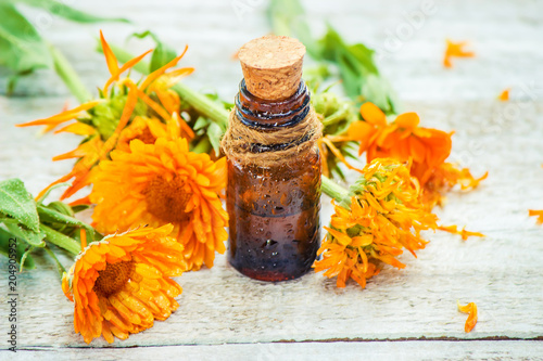 Fotografie, Obraz The calendula extract. Medicinal plants. Selective focus.