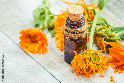 Fotografie, Obraz The calendula extract. Medicinal plants. Selective focus.