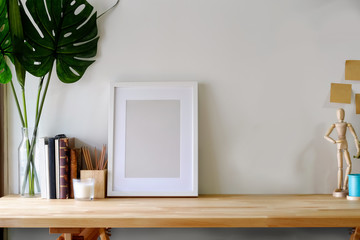 Mockup poster on wooden table with copy space.