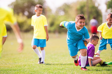 Young children players football match on soccer field