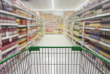 Fototapeta  - Supermarket aisle with empty shopping cart