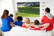© Syda Productions - sport, leisure and entertainment concept - friends or football fans watching soccer game on projector screen at home