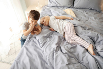 Wall Mural - Cute children with toy on bed at home