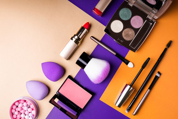 makeup products and decorative cosmetics on color background flat lay. fashion and beauty blogging c