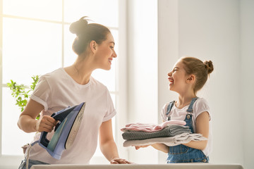 Wall Mural - mother and daughter ironing at home