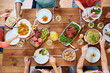 © Syda Productions - thanksgiving day, eating and leisure concept - group of people having dinner at table with food