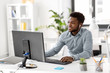 © Syda Productions - business, technology and people concept - happy african american businessman with earphones and computer computer listening to music at office