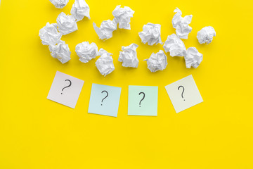 Poster - FAQ concept. Question mark on sticky notes near crumpled paper on yellow background top view copy space
