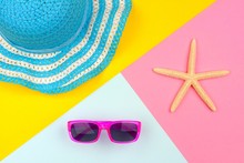 Summer Accessories: Sunglasses, Hat And Starfish, With Bright Modern Summer Background, Top View, Minimal Yellow, Pink And Blue Pattern.