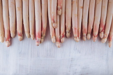 bunch of white asparagus decorated on a white wood table, can be used as background