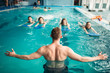 © Nomad_Soul - Trainer works with female group in swimming pool