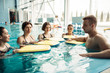 © Nomad_Soul - Trainer swims with class on aqua aerobics workout