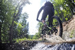 Mountain biker creates a splash of water