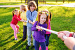 © Evgeniy Kalinovskiy - Children play tug of war in the park. Children's Day, June 1, friendship, childhood, vacation, camp