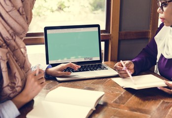 Poster - Islamic women discussing and using laptop for working