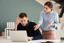 Office Employees Having Argument At Workplace