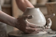 potter sculpts a vase on a potter's wheel
