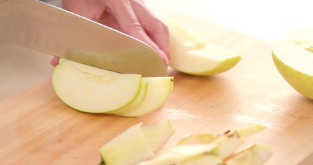 Canvas Print - Hands cutting an apple