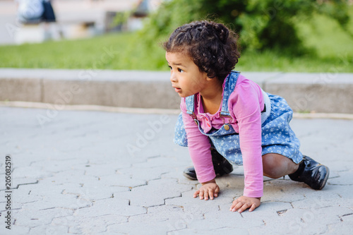 Dark Skinned Hispanic Toddler Girl Crawling Outdoor Caucasian