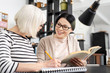 © Viacheslav Yakobchuk - Rewrite it. Cheerful tutor carrying book while senior woman taking notes