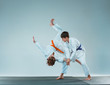 © master1305 - The two boys fighting at Aikido training in martial arts school. Healthy lifestyle and sports concept