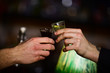 © be free - Male hands cheers with alcohol on blurred bar background.
