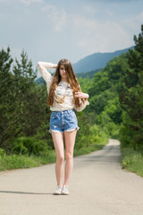 Wall Mural - Gorgeous young female model outdoors on sunny summer day wearing boho outfit. No retouch, natural lighting.