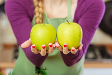 Woman Holding Two Apples