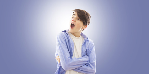 Wall Mural - portrait of a young man with a surprise expression on the blue background