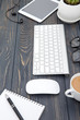 Modern workplace with smartphone and keyboard copy space on wood background. Top view. coffee cup.