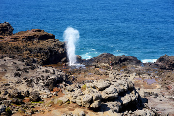 Poster - Tourists admiring the Nakalele blowhole on the Maui coastline. A jet of water and air is violently forced out through the hole in the rocks, Hawaii