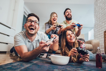 group of friends play video games together at home, having fun.