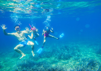 Wall Mural - Family dives into the sea in masks