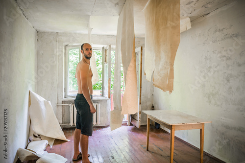 The Man Shoots Wallpaper Hanging From Ceiling Worker The Man Shoots Wallpaper Hanging From Ceiling Worker Performs Repair Of