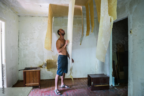 The Worker Rips Off The Wallpaper From The Ceiling Stripes