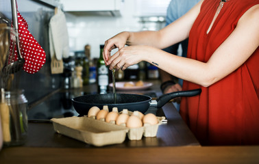 Canvas Print - Caucasian woman coloking eggs in the kitchen