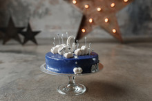 Dark Blue Birthday Cake With White Decor And Number 1 On Concrete Wall Background And Star