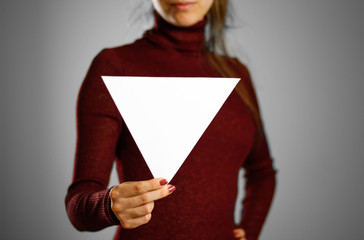 Wall Mural - Woman showing blank triangular white paper. Leaflet presentation. Pamphlet hold hands. Girl show clear offset paper. Sheet template