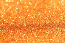 Orange Glitter Lights Background. Defocused.