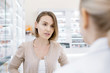 © zinkevych - Health trouble. Disconcerted attractive woman posing on blurred background while speaking with female pharmacist
