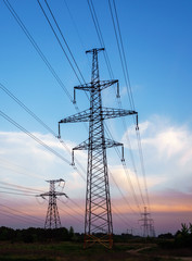 Wall Mural - silhouette high voltage electric tower on sunset time and sky on sunset time background.