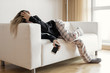 Apathic lazy woman lying in sofa
