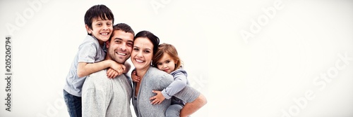 Cuadros en Lienzo Happy parents giving children piggyback rides