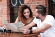 © ASDF - A picture of  tourists looking at map in a cafe